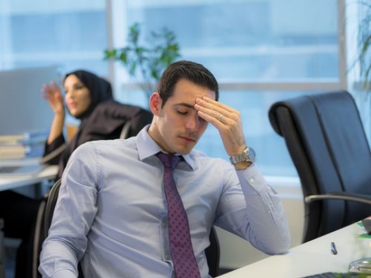 Employee sitting by the desk having trouble|-