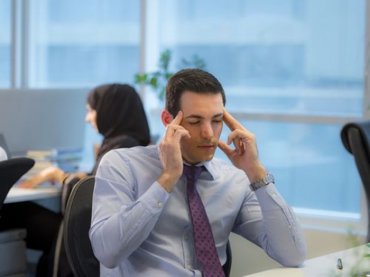 Portrait of an arab employee with a headache|-