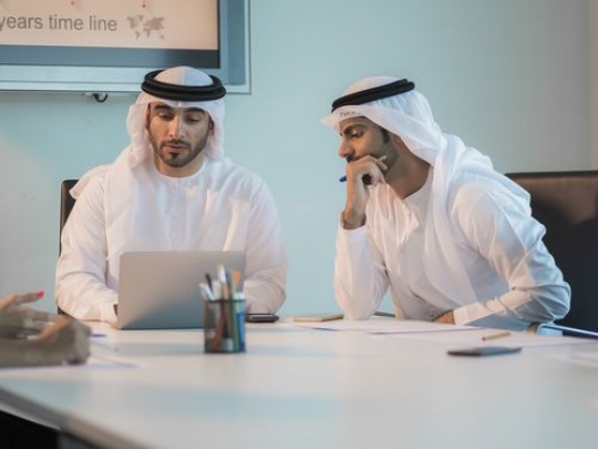 Business people during a meeting at the office wearing the traditional attire|-