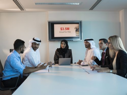 Businesspeople talking to each other during a meeting|-