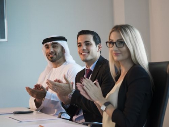 Employees clapping hands during a meeting|-