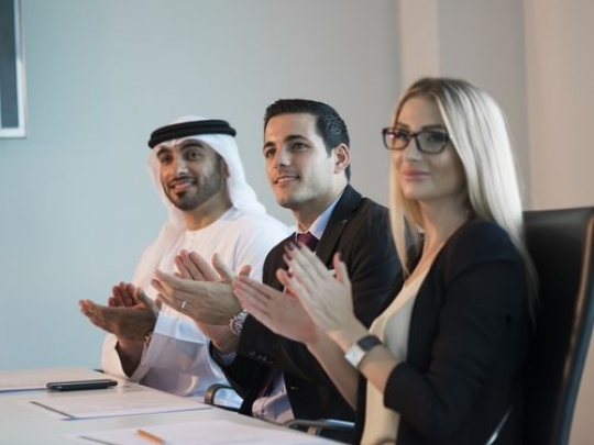 Businesspeople clapping hands during a meeting|-
