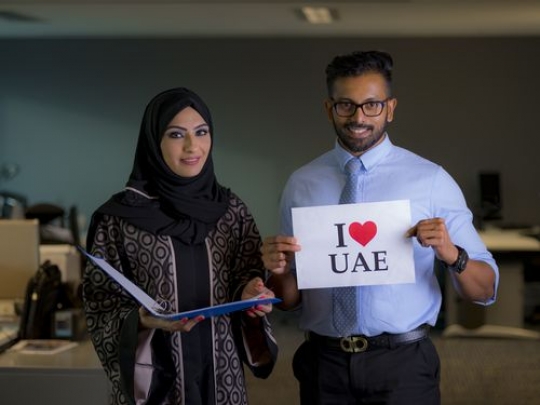 Medium shot of two business people celebrating National Day|-