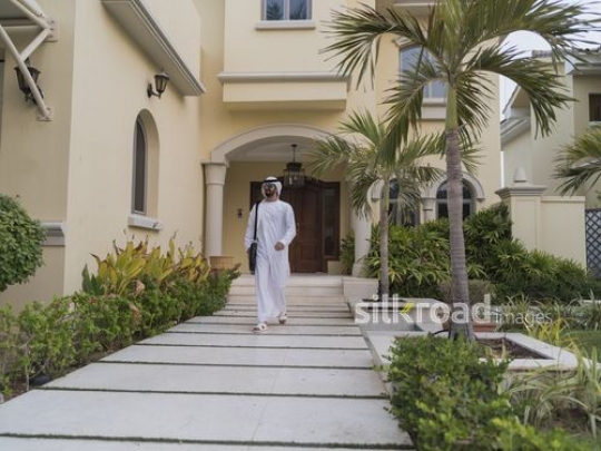 Middle Eastern man walking outside|