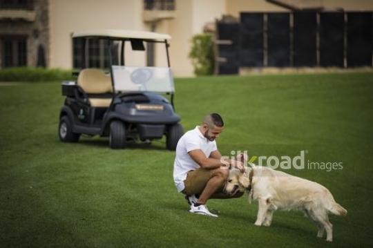 Arab man petting the dog |-