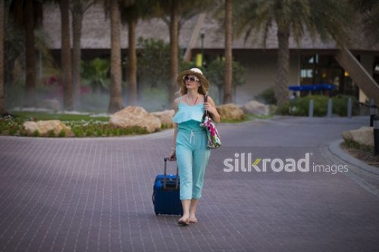 Western woman leaving the resort|-