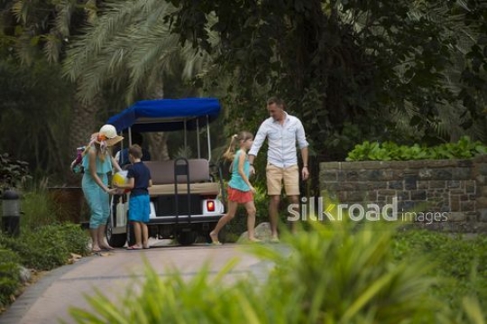 Western family getting dropped off by the golf cart|-