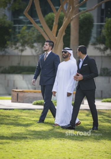 Three Businessmen walking together outside|-