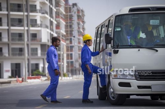 Construction workers entering the bus|-