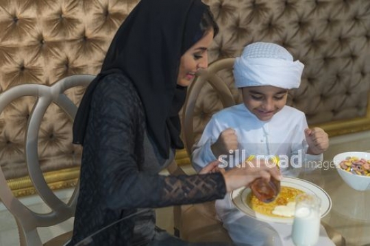 Middle Eastern kid excited about pancakes|