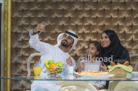 Middle Eastern family taking a selfie together|