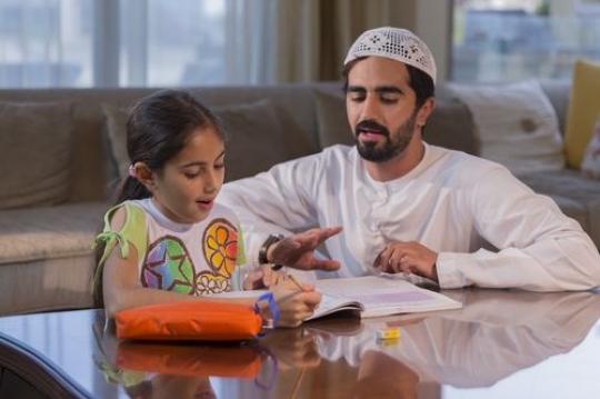 Arab daughter getting help from her father|-