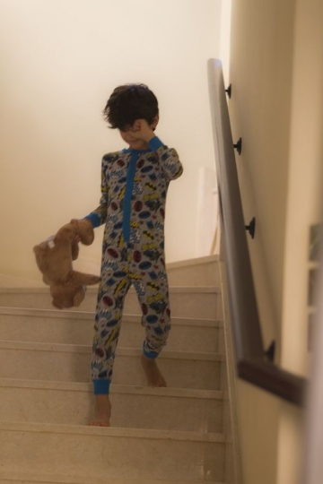 Middle Eastern boy walking down the stairs |-