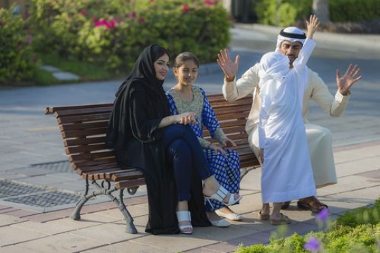 Middle eastern family dressed in traditional wear spending time with each other|-