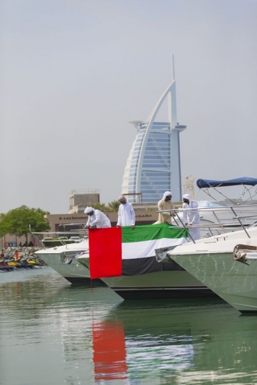 Arab family and friends representing their country on a Yacht with the UAE Flag|