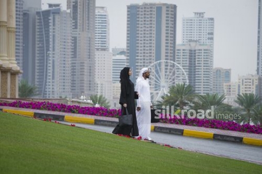 Middle Eastern Businessman and Businesswoman walking together |-