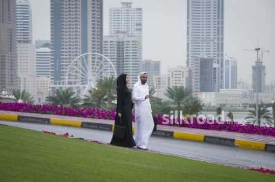 Businessman and business woman walking together|-