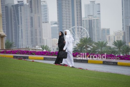 Arab business man and business woman walking together|-