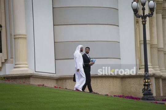 Middle Eastern Businesspeople walking outside|-