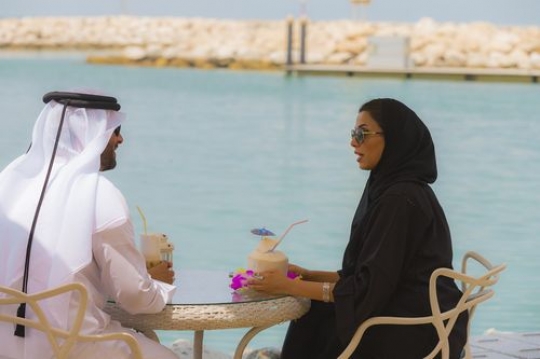 Arab friends are sitting outside and talking to each other|