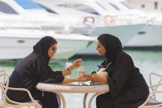 Women sitting outside and talking to each other|