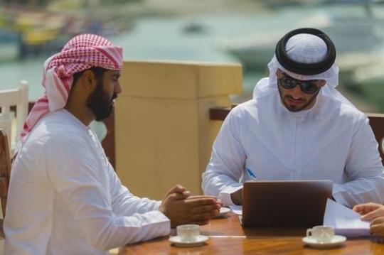Business men sitting outside together during a meeting|
