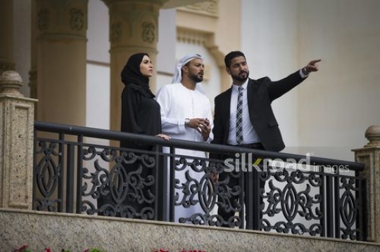 Businessmen and Businesswoman standing on the bridge together|-