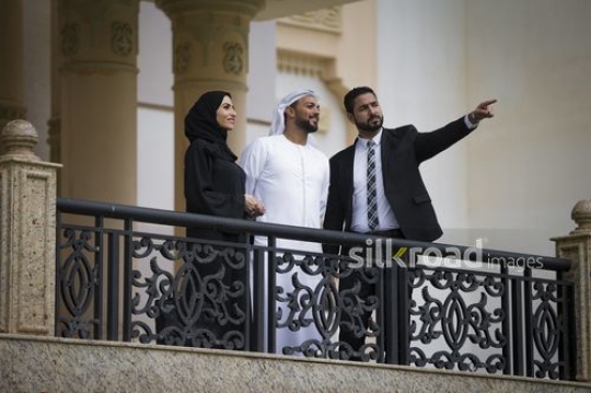 Businesspeople standing together on the bridge talking to each other|-