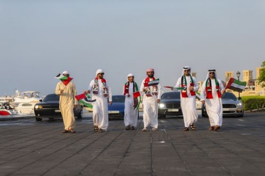 Emirati men folllowed by luxurious participating during the UAE National day parade|-