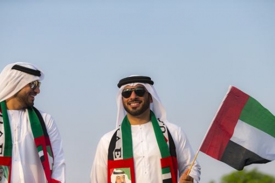 Middle eastern men dressed in traditional UAE attire representing their country|-