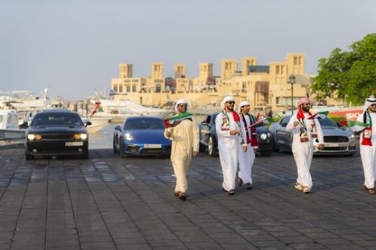 Arab men and luxury cars during a National Day Parade|-