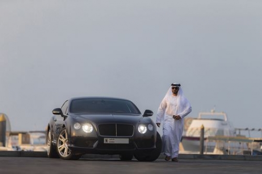Arab man leaving his black luxury vehicle|-