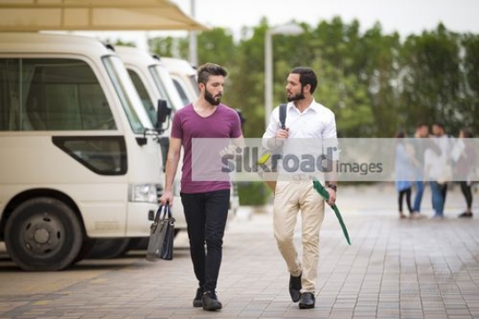 Middle Eastern men walking together on campus|