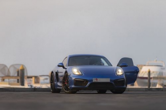 Man exiting the blue luxury car|-