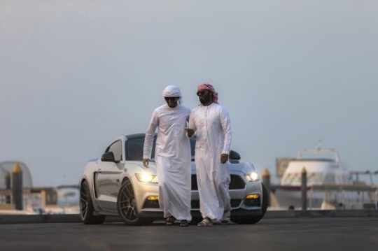 Two arab men walking away from parked vehicle|-