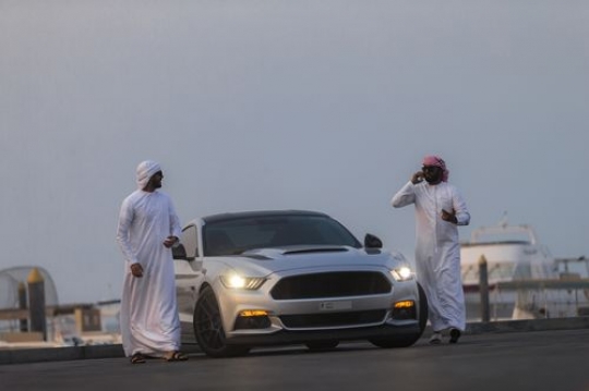 Middle eastern men walking away from the luxury car|-