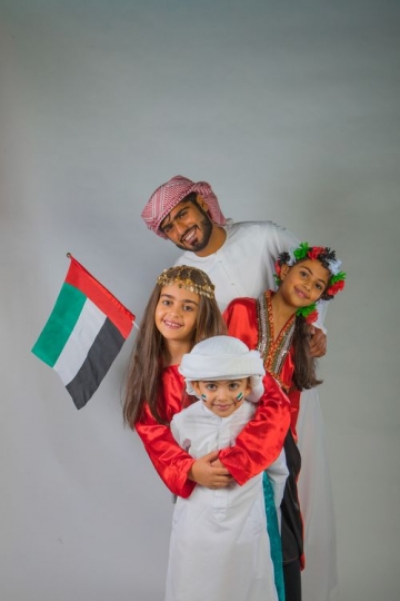 Family taking a photo together for National Day