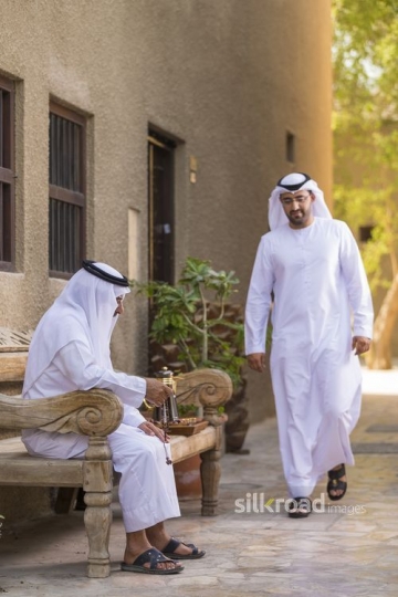 Arab son walking towards his father|-