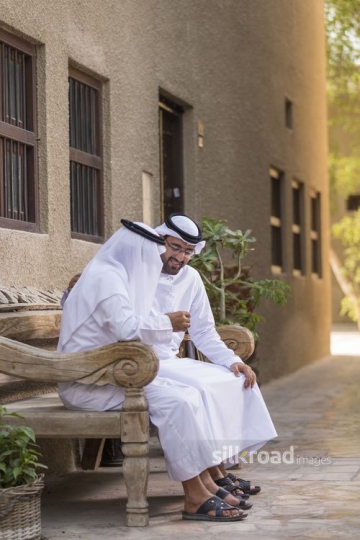 Arab grandfather and father sitting together |-