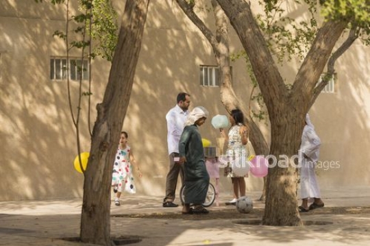 Arab kids having cotton candy playing around|-