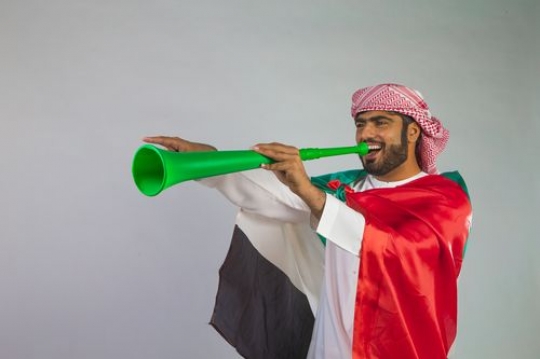Man dressed in the traditional attire celebrating the UAE