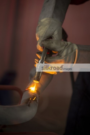 Engineer using machine to cut through the metal|