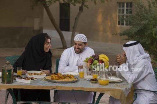 REPLACE - Middle Eastern family talking to each other during Iftar|-