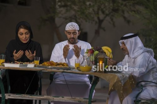 REPLACE - Arab family praying together before Iftar|-
