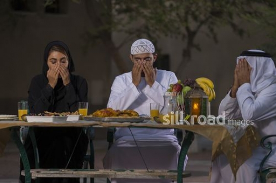 REPLACE - Arab family praying before Iftar|-