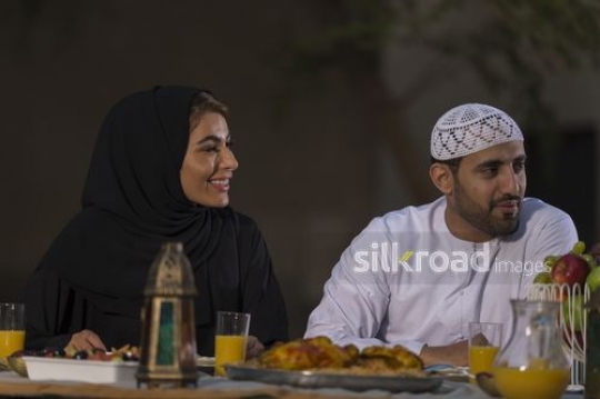 Arab man and woman sitting together|-