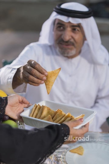 Arab man filling his plate|-