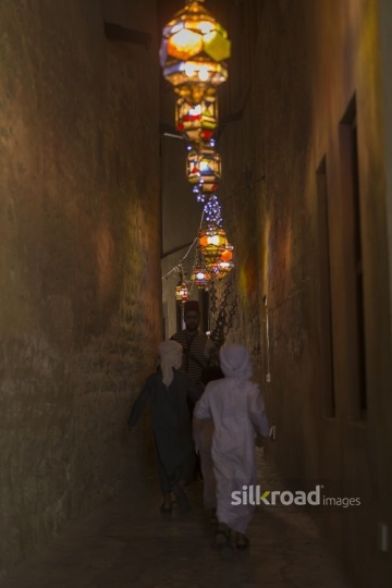 Middle Eastern Ramadan drink seller offering young kids juice|-