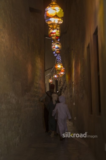 Middle Eastern Ramadan drink seller offering young kids some juice|-