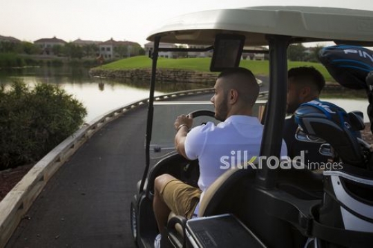 Middle Eastern men driving around with the Golf Cart|-